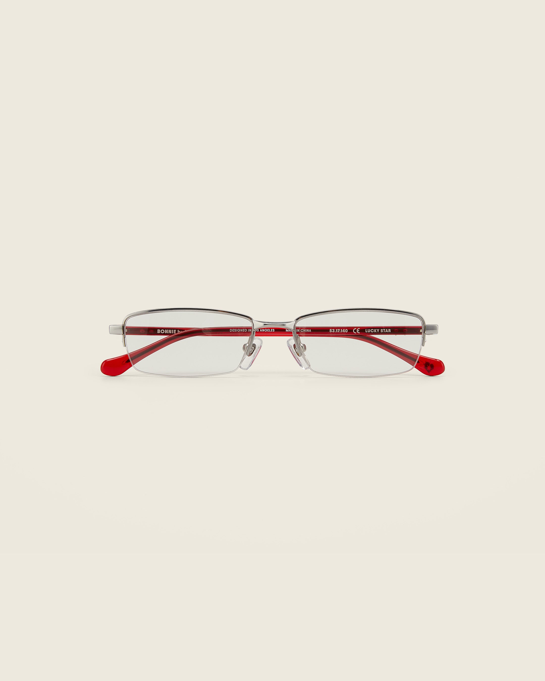Bonnie Clyde Lucky Star Glasses. Silver frames with clear lenses and red arm temples.