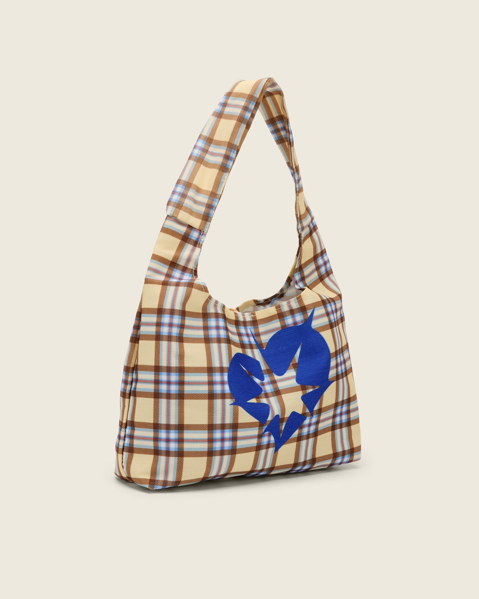 Bonnie Clyde® plaid tote bag with blue heart design on a beige background, side angle