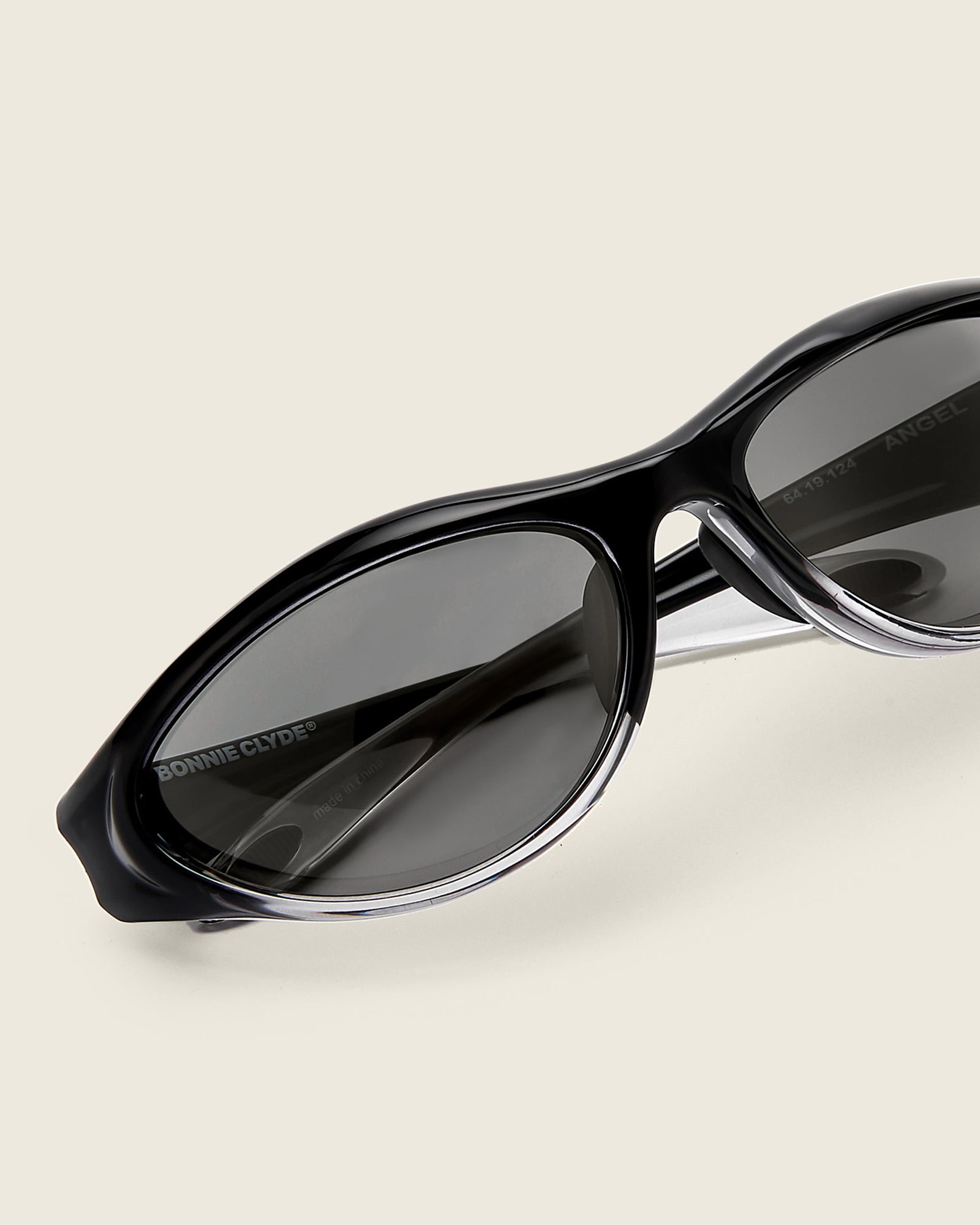 Bonnie Clyde Angel black curved TR90 sunglasses with black lenses, detail view.