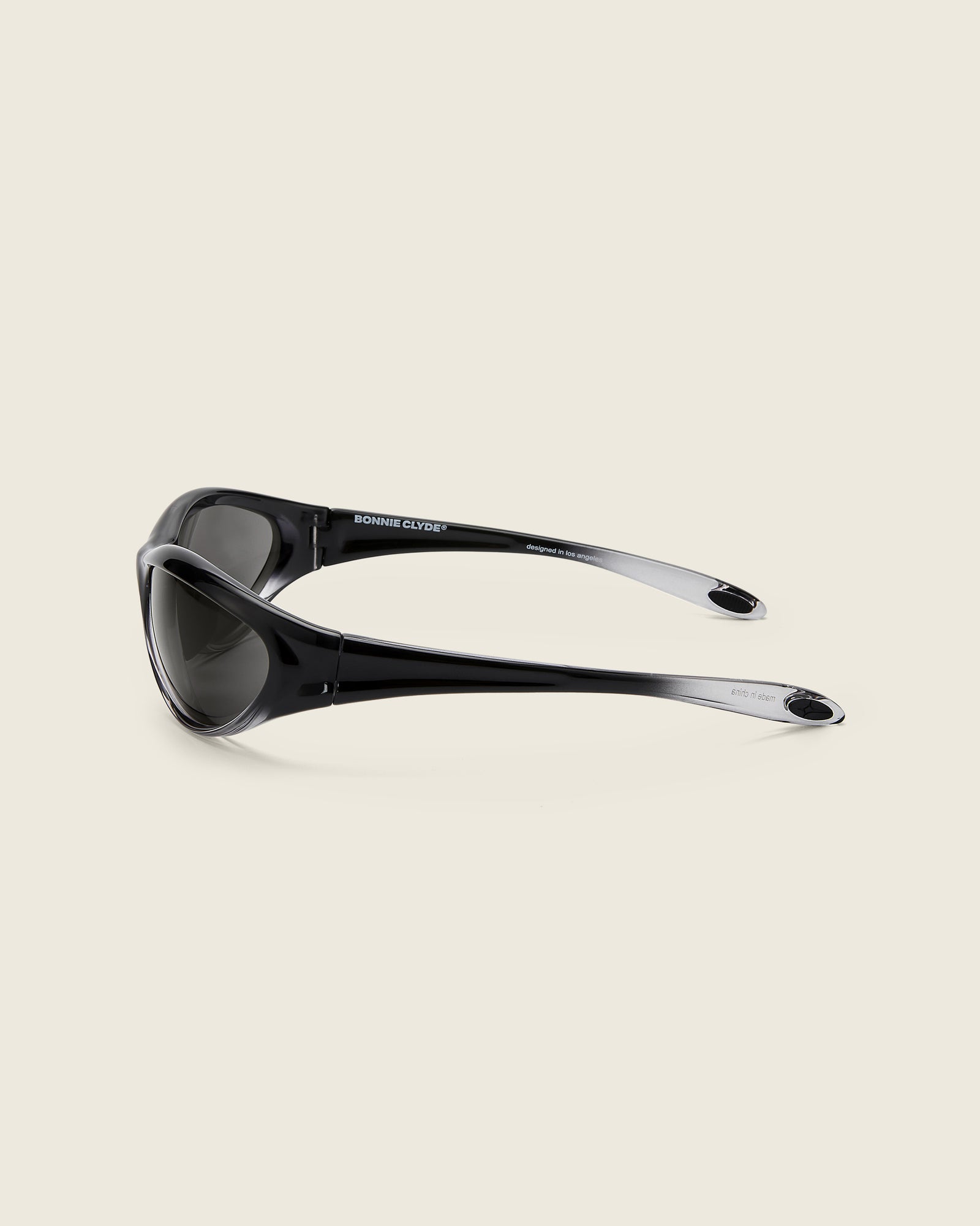 Bonnie Clyde Angel black curved TR90 sunglasses with black lenses, side view.