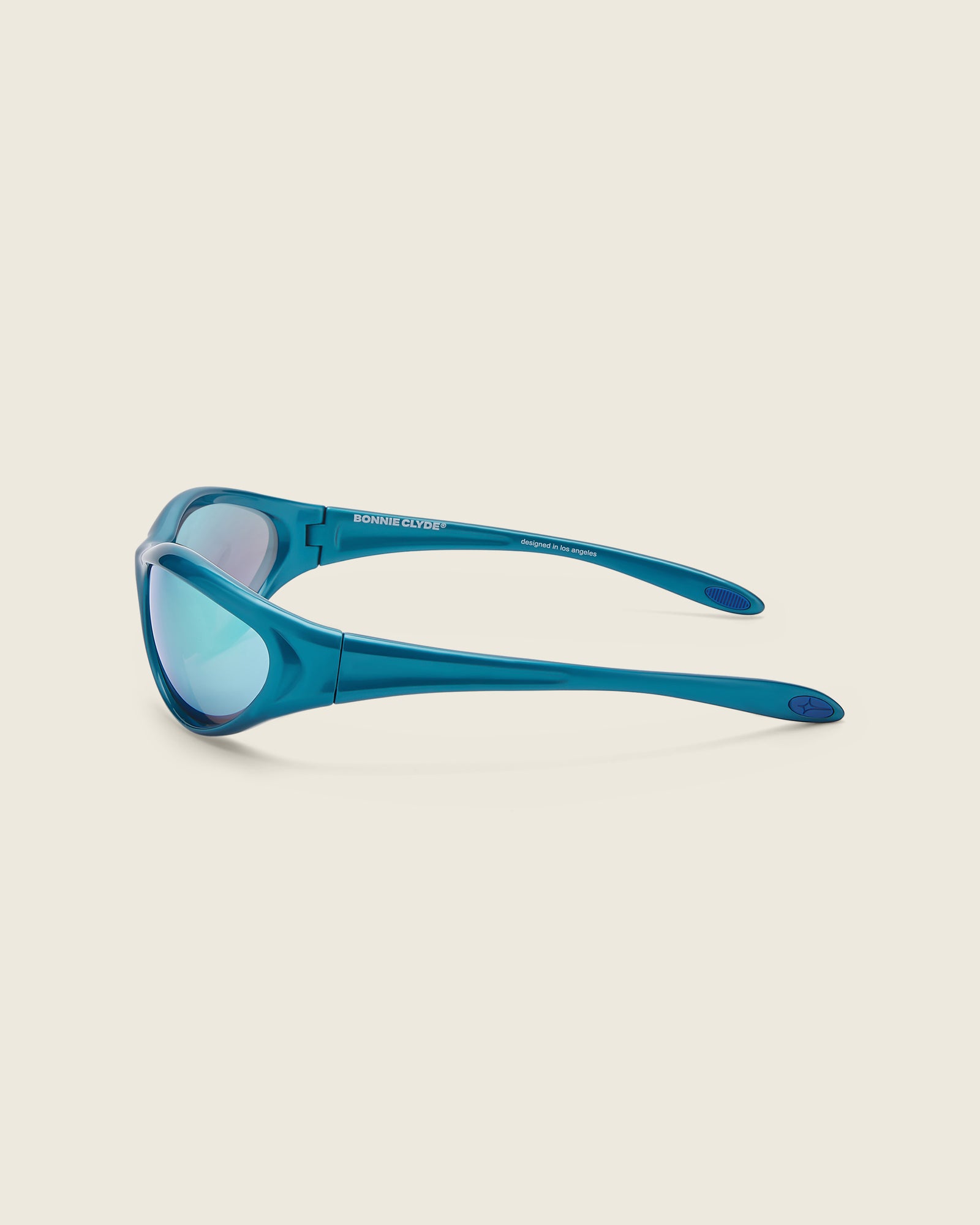Bonnie Clyde Angel metallic blue curved TR90 sunglasses with blue lenses, side view.