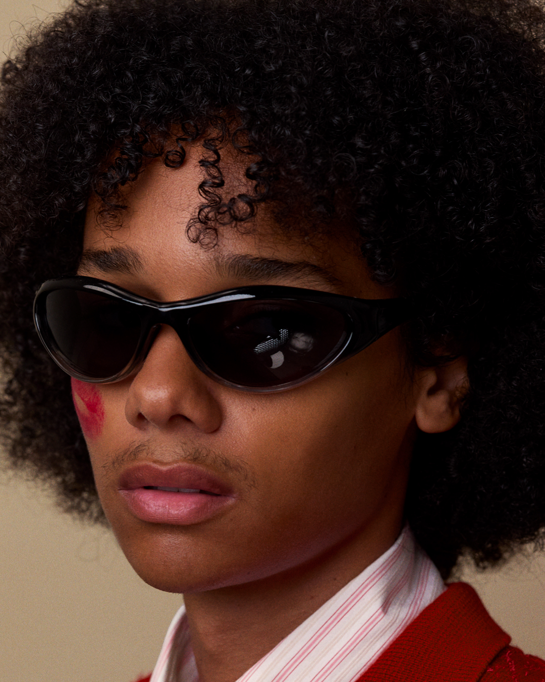 Bonnie Clyde Angel black curved TR90 sunglasses with black lenses, styled on  model's face.