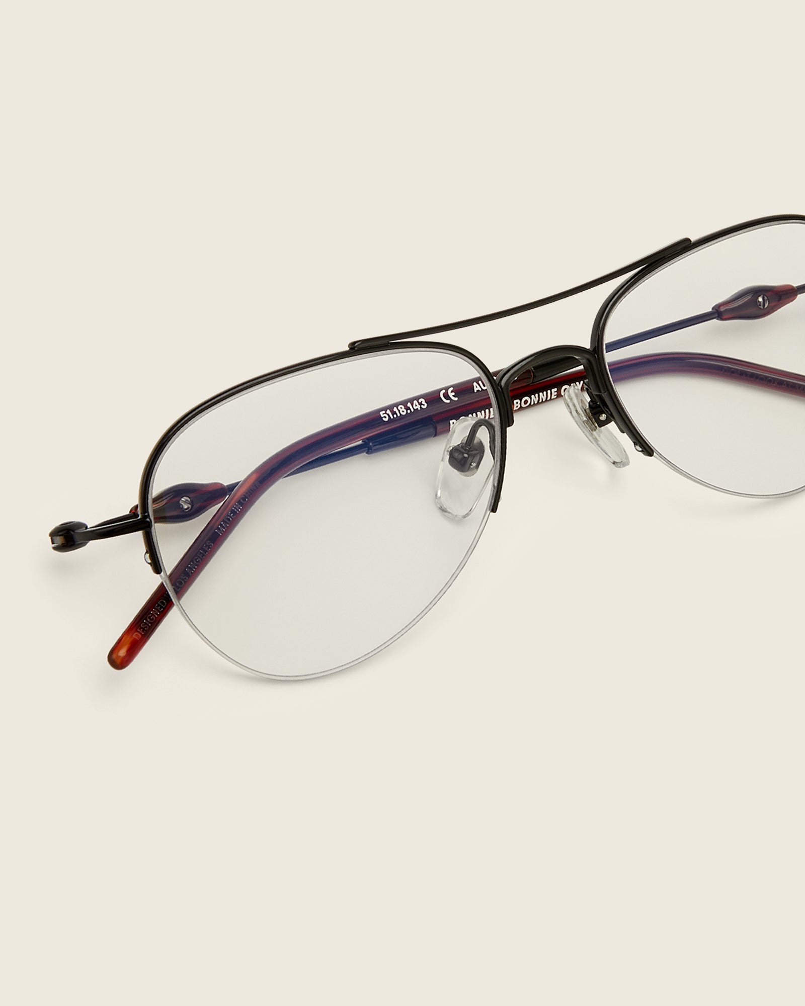 Bonnie Clyde Autobio aviator opticals in black titanium with clear lenses and exploding heart acetate bead detailing on the arms, detail view.