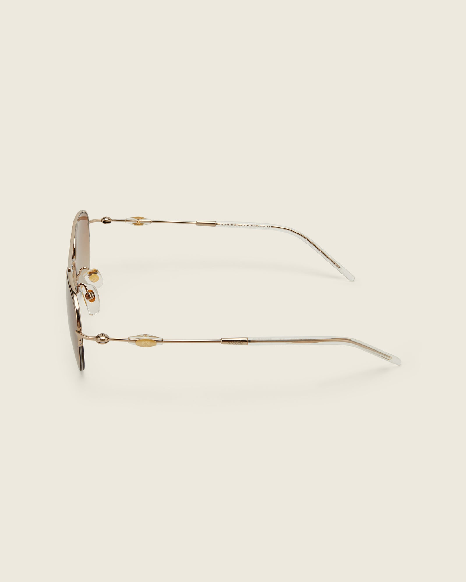Bonnie Clyde Autobio aviator opticals in gold titanium with brown lenses and exploding heart acetate bead detailing on the arms, side view.