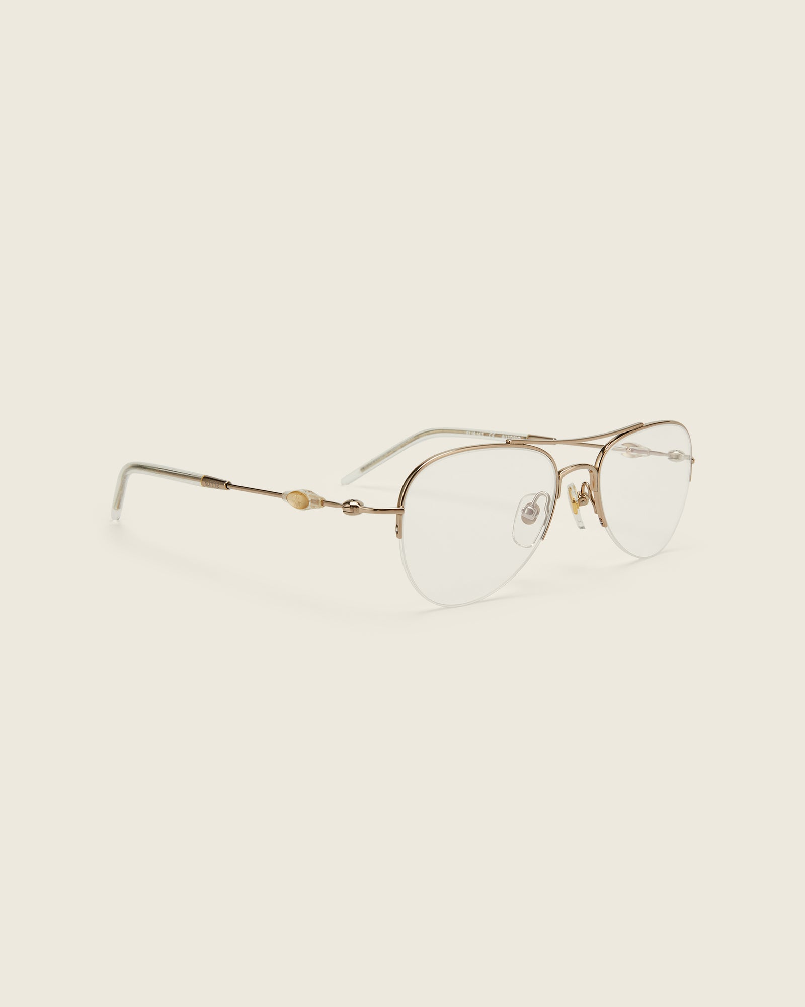 Bonnie Clyde Autobio aviator opticals in gold titanium with clear lenses and exploding heart acetate bead detailing on the arms, quarter view.