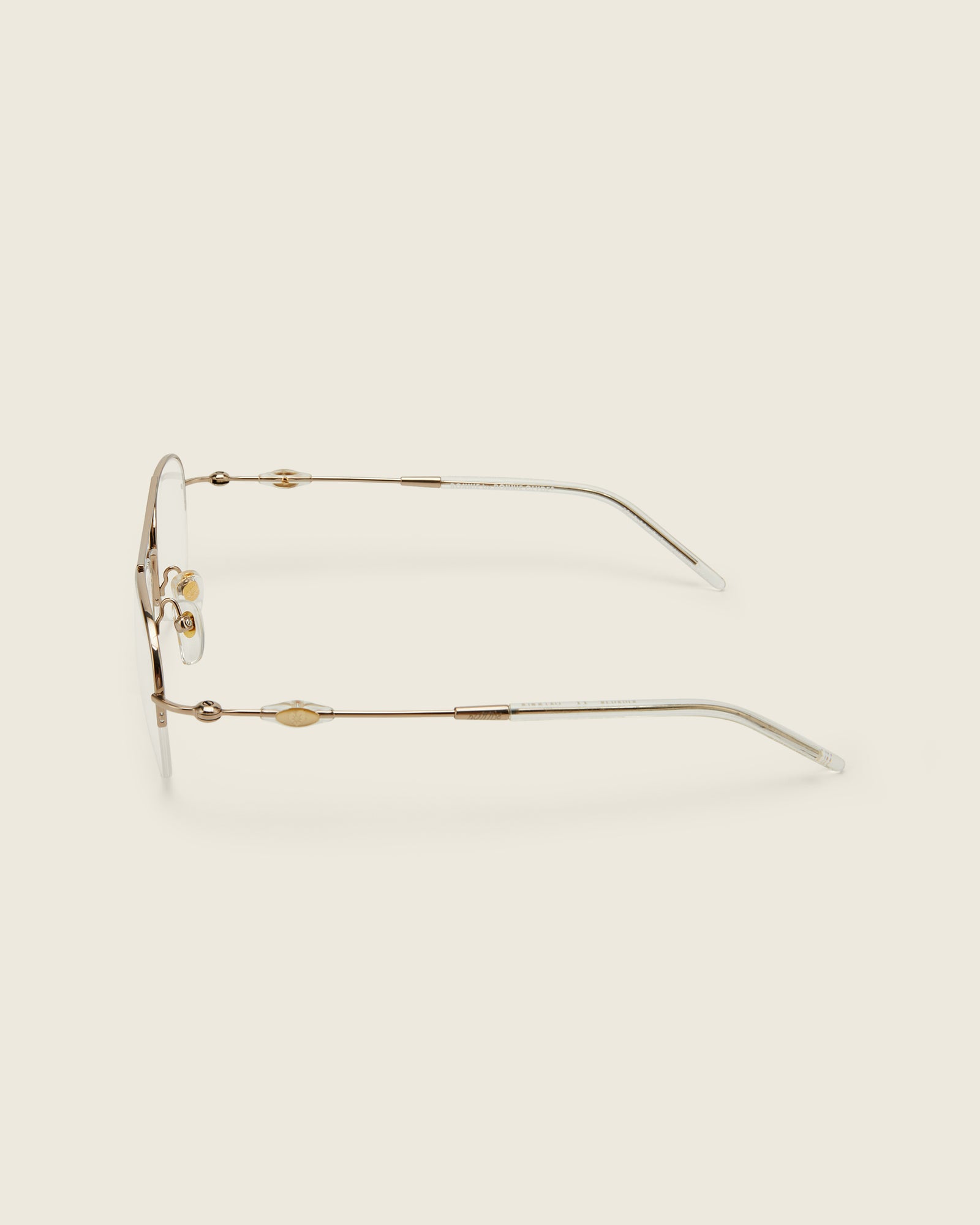 Bonnie Clyde Autobio aviator opticals in gold titanium with clear lenses and exploding heart acetate bead detailing on the arms, side view.