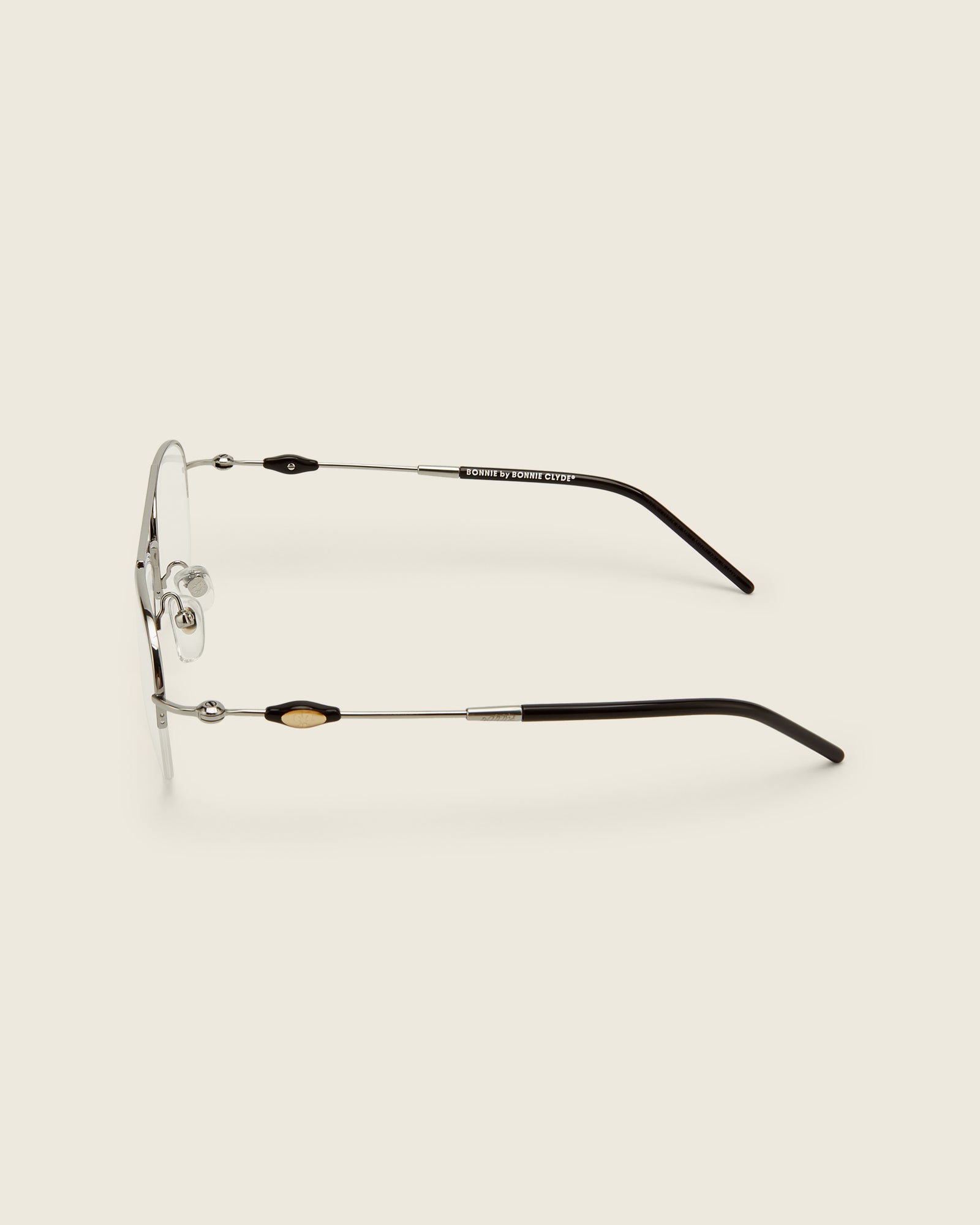 Bonnie Clyde Autobio aviator opticals in silver titanium with  blue light filtering lenses and exploding heart acetate bead detailing on the arms, side view.