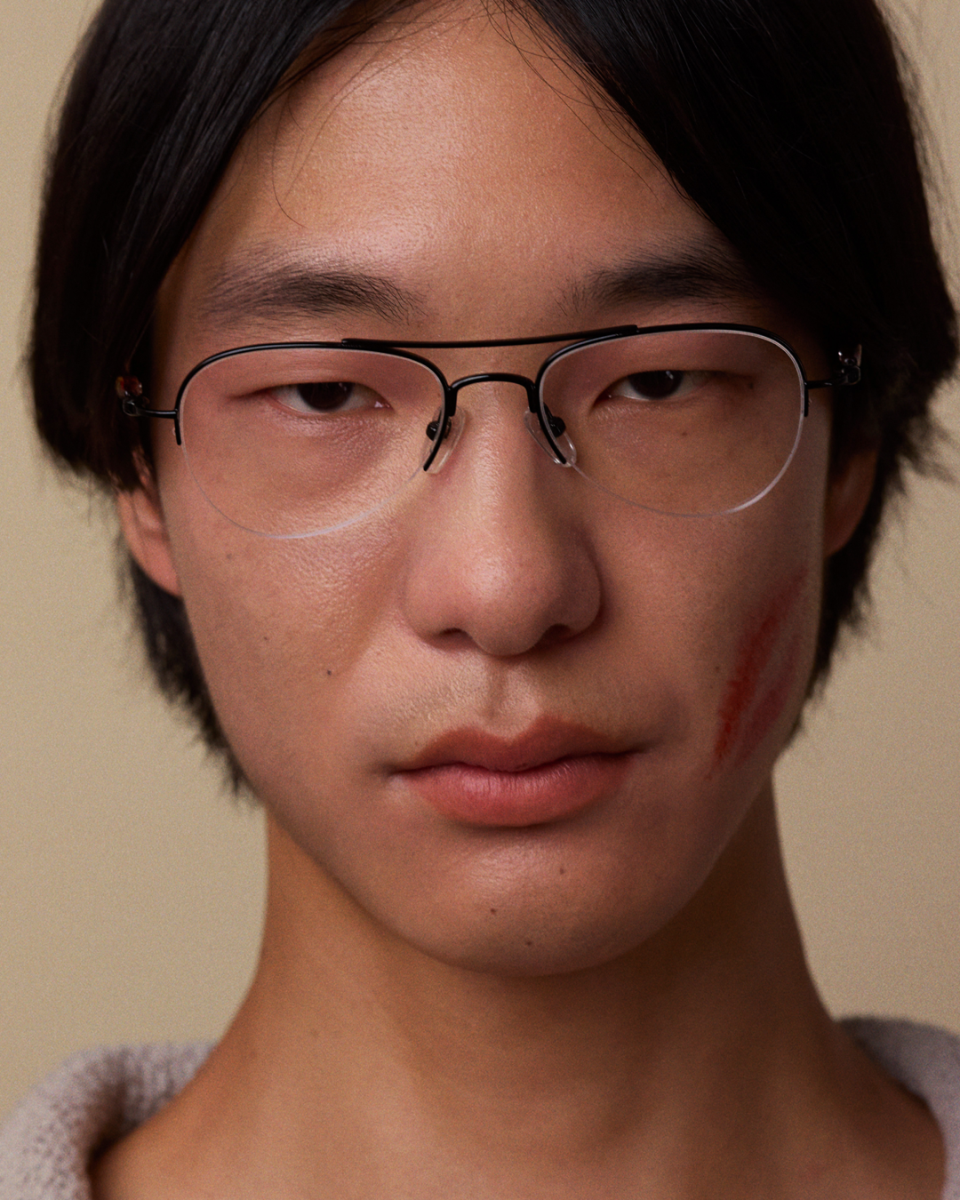 Bonnie Clyde Autobio aviator opticals in black titanium with clear lenses and exploding heart acetate bead detailing on the arms, on a model's face.