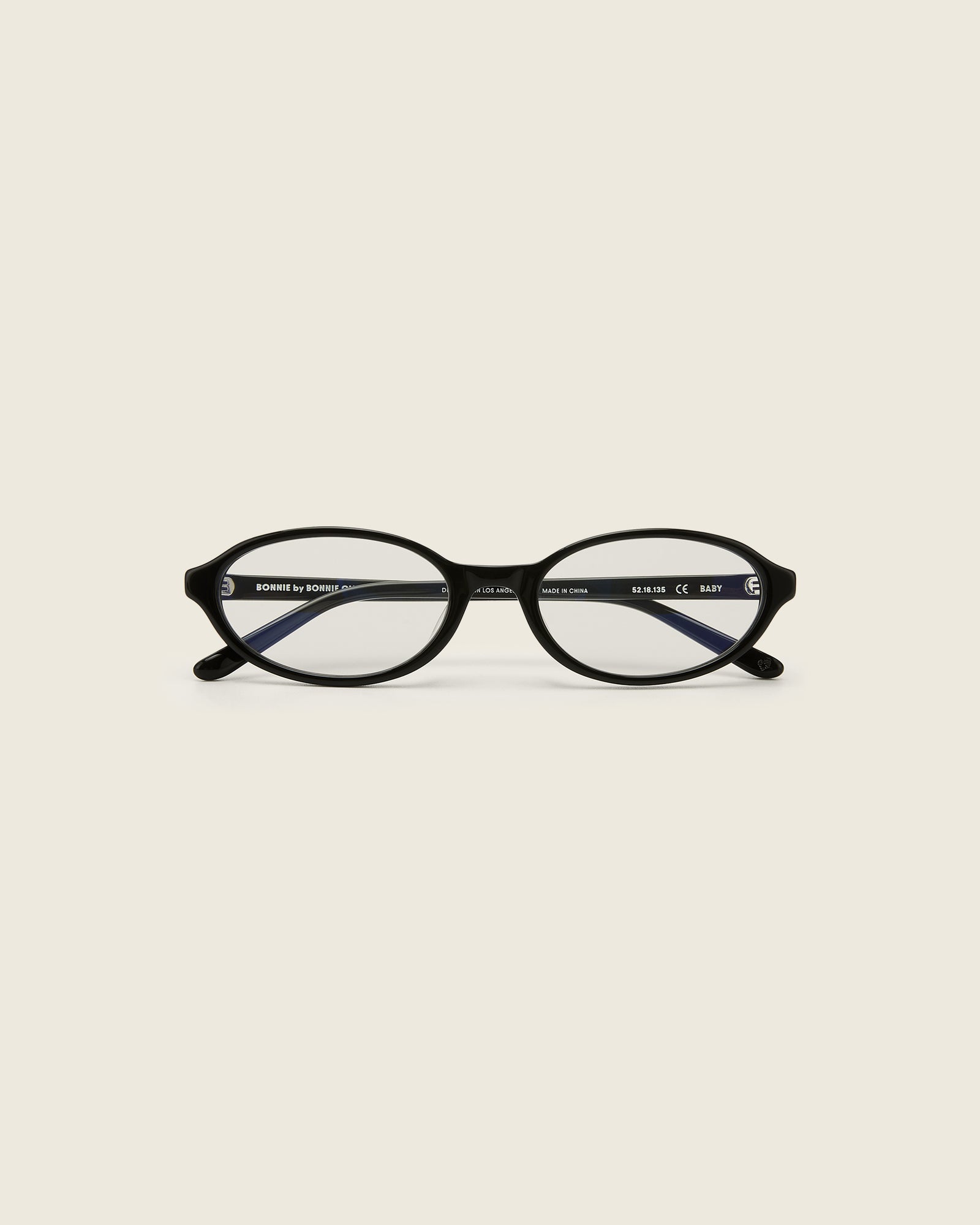Bonnie Clyde Baby oval optical in black acetate with clear lenses and double heart detailing on the arms, front view