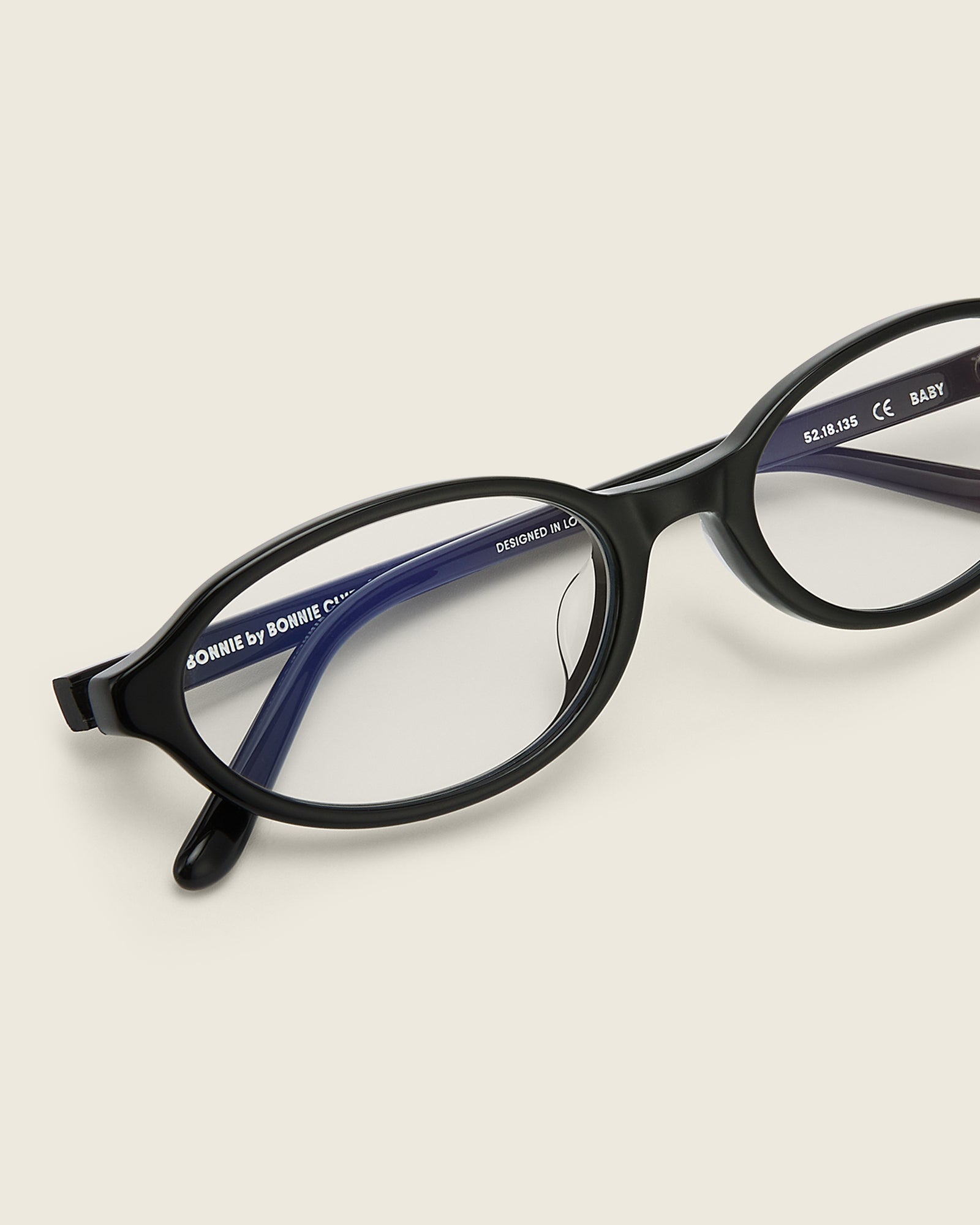 Bonnie Clyde Baby oval optical in black acetate with clear lenses and double heart detailing on the arms, detail view