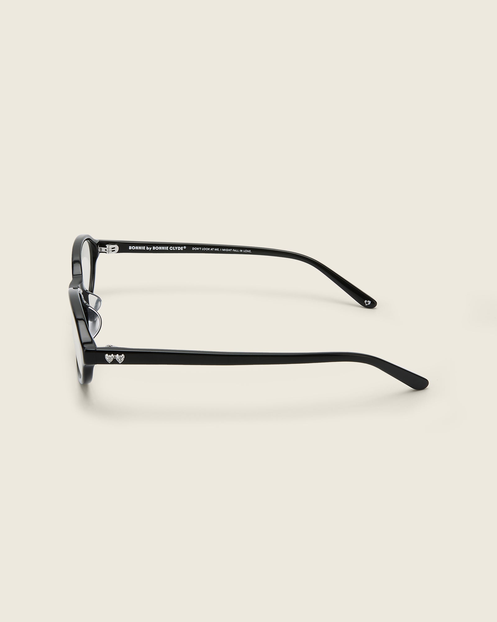 Bonnie Clyde Baby oval optical in black acetate with clear lenses and double heart detailing on the arms,  side view