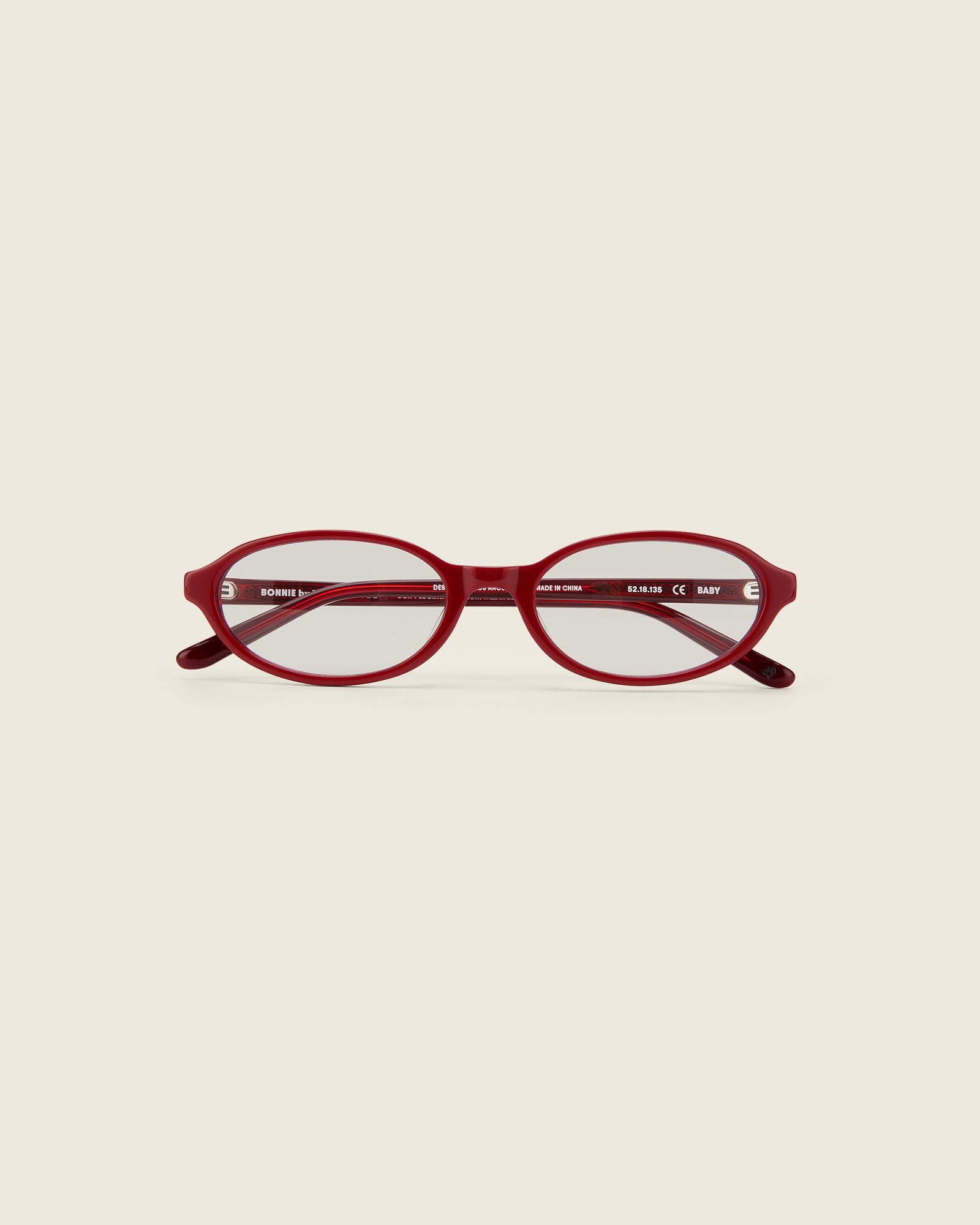 Bonnie Clyde Red oval-shaped acetate glasses with clear lenses, featuring double heart detailing on the temples.
