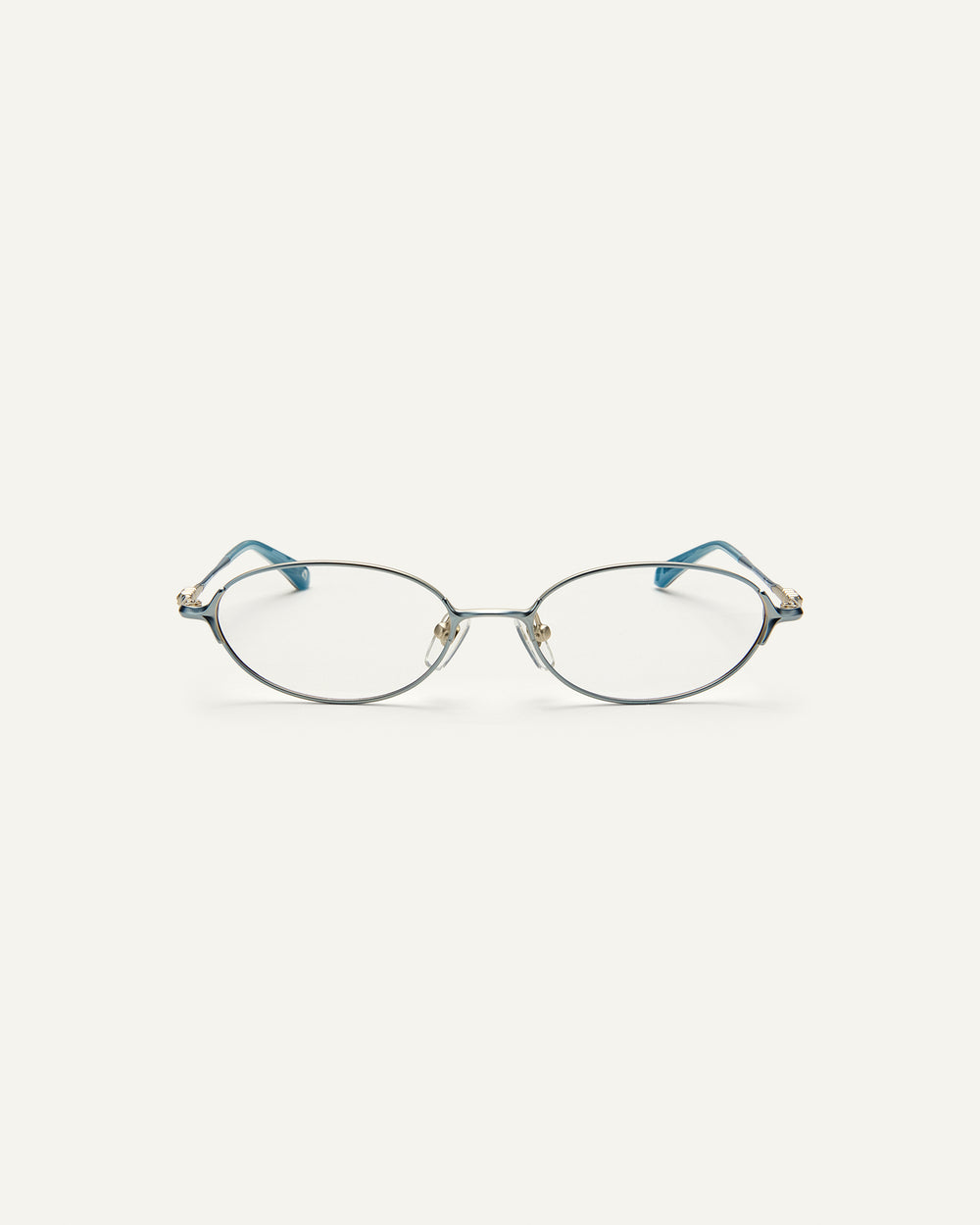 Face shot of Bonnie Clyde Bunny eyeglasses in titanium silver with teal acetate and clear lenses. 