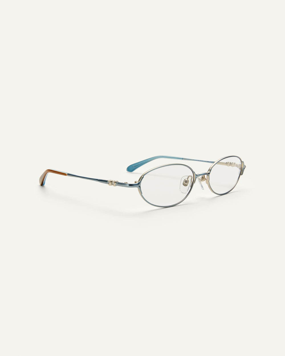 Quarter shot of Bonnie Clyde Bunny eyeglasses in titanium silver with teal acetate and clear lenses. 