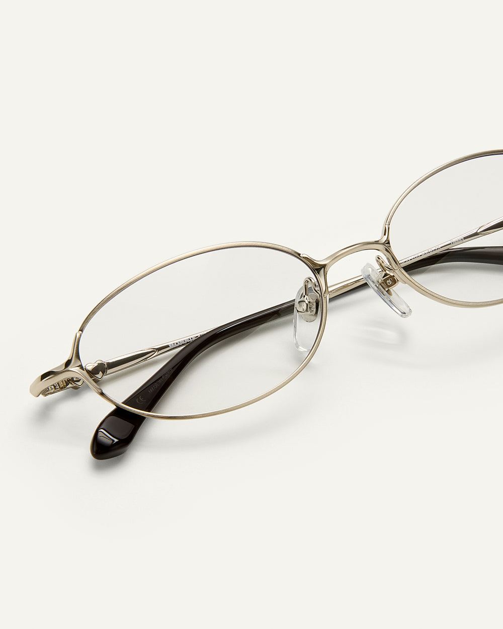 Close up shot of Bonnie Clyde Bunny eyeglasses in titanium silver with brown acetate and clear lenses. 