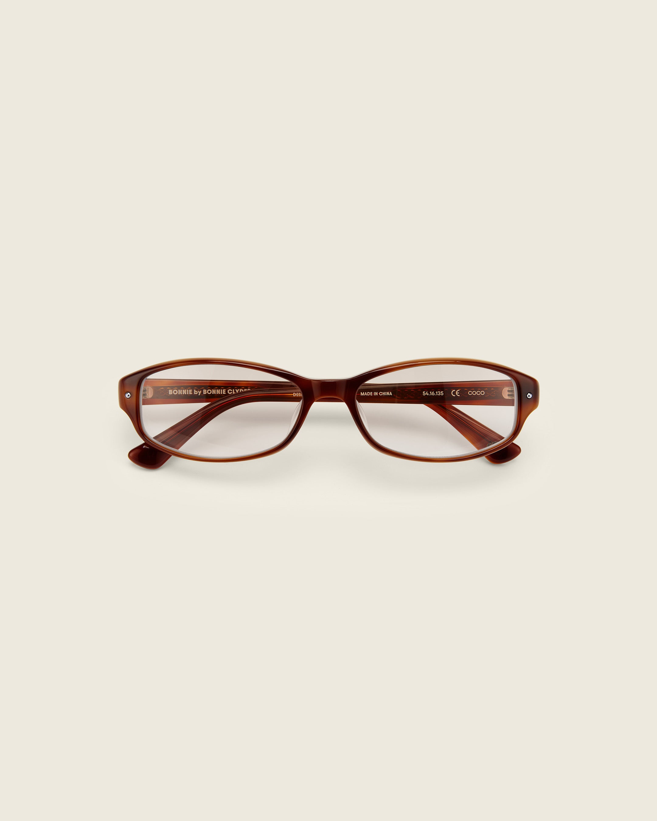 Bonnie Clyde Coco Glasses. Layered brown frames with clear lenses.