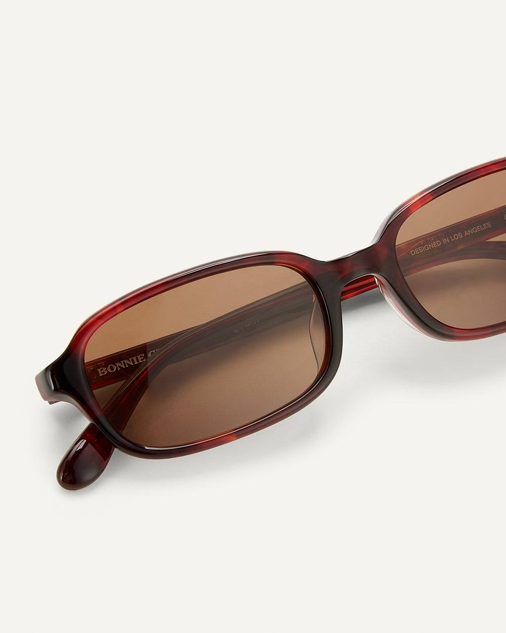Close-up shot of Bonnie Clyde Comedy sunglasses in Red Tort.