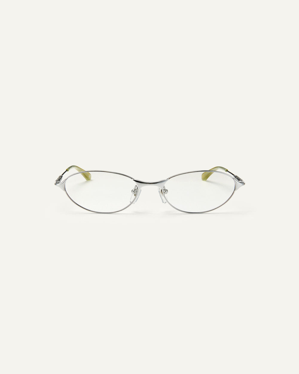 Face shot of Bonnie Clyde Intro eyeglasses in silver titanium frames with green acetate details and clear lenses.