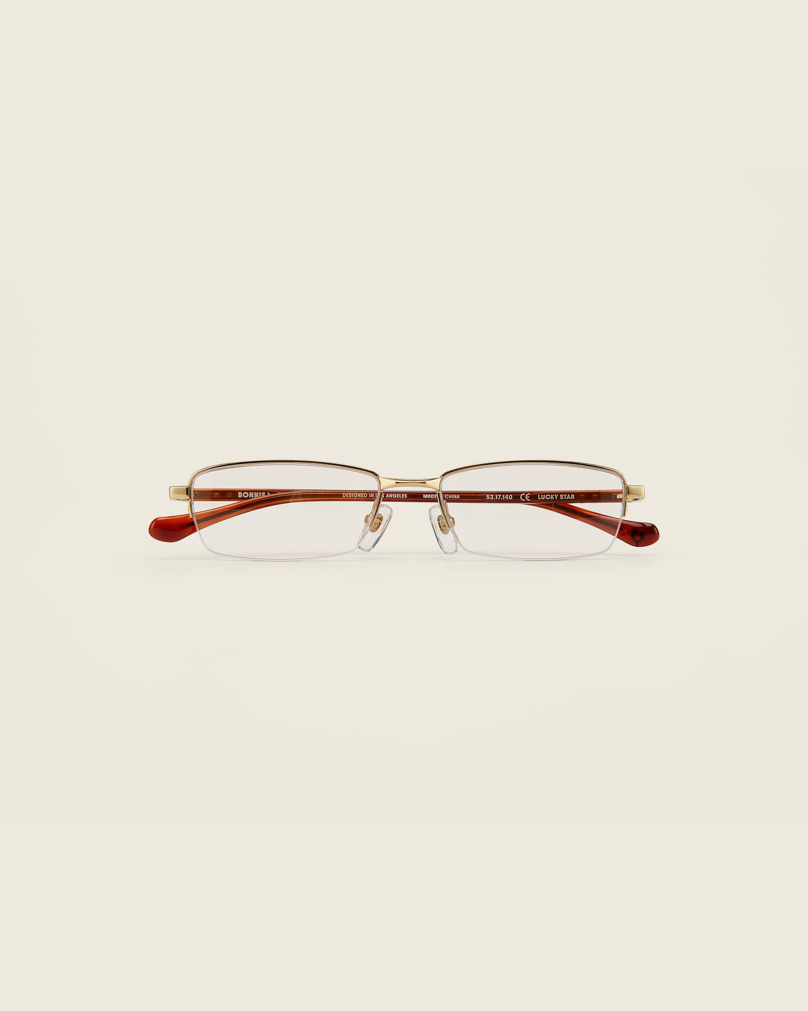 Bonnie Clyde Lucky Star Glasses. Gold frames with clear lenses and tortoise arm temples.