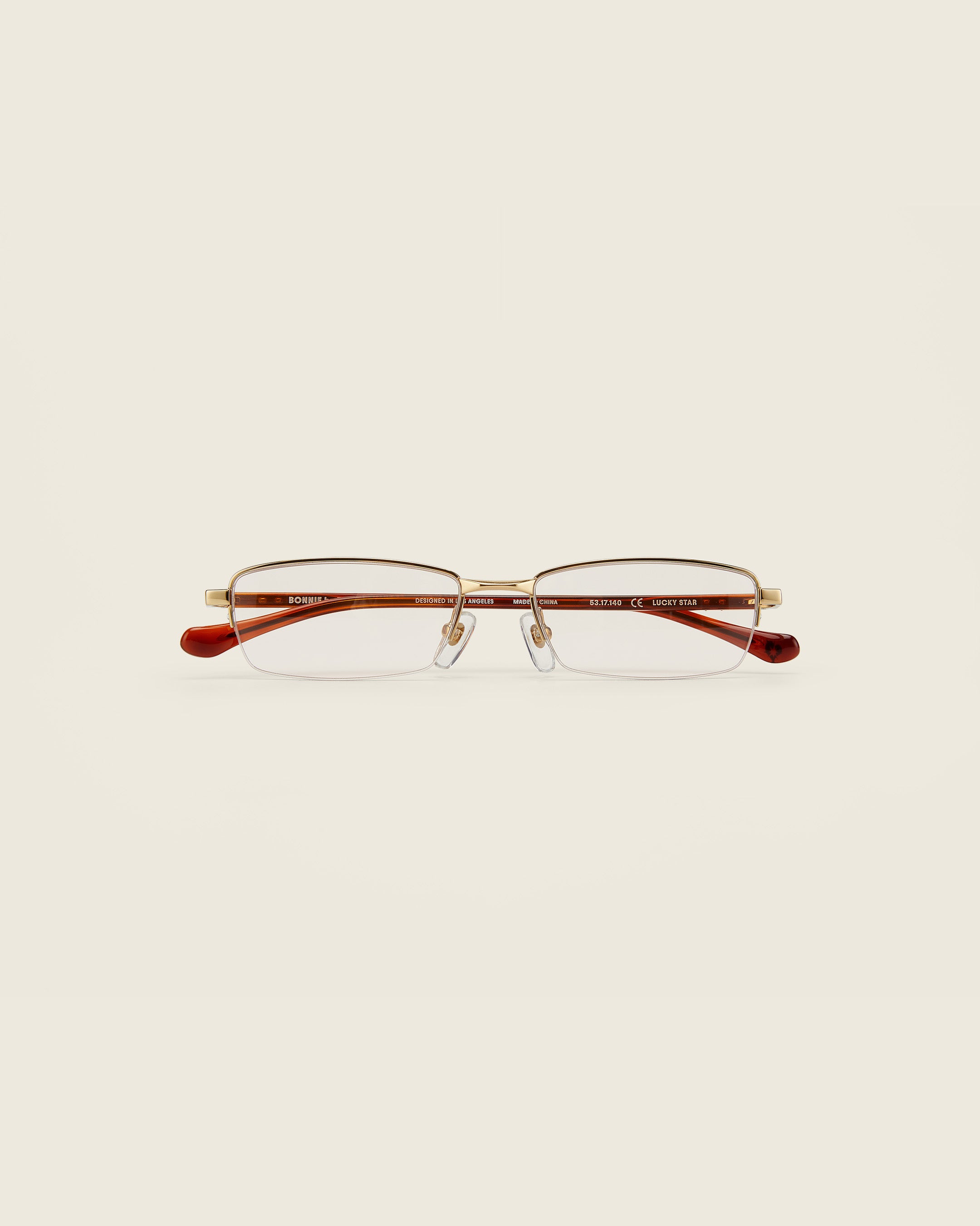 Bonnie Clyde Lucky Star Glasses. Gold frames with clear lenses and tortoise arm temples.