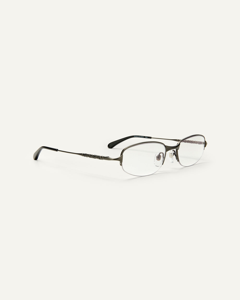 Quarter shot of Bonnie Clyde Outro eyeglasses in gunmetal titanium frames with black acetate details and clear lenses.