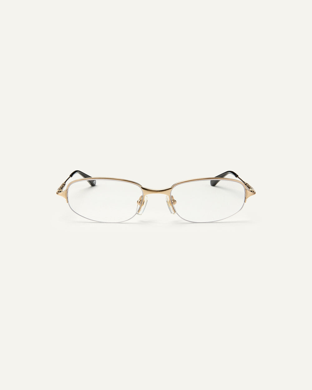 Face shot of Bonnie Clyde Outro eyeglasses in gold titanium frames with black acetate details and clear lenses.