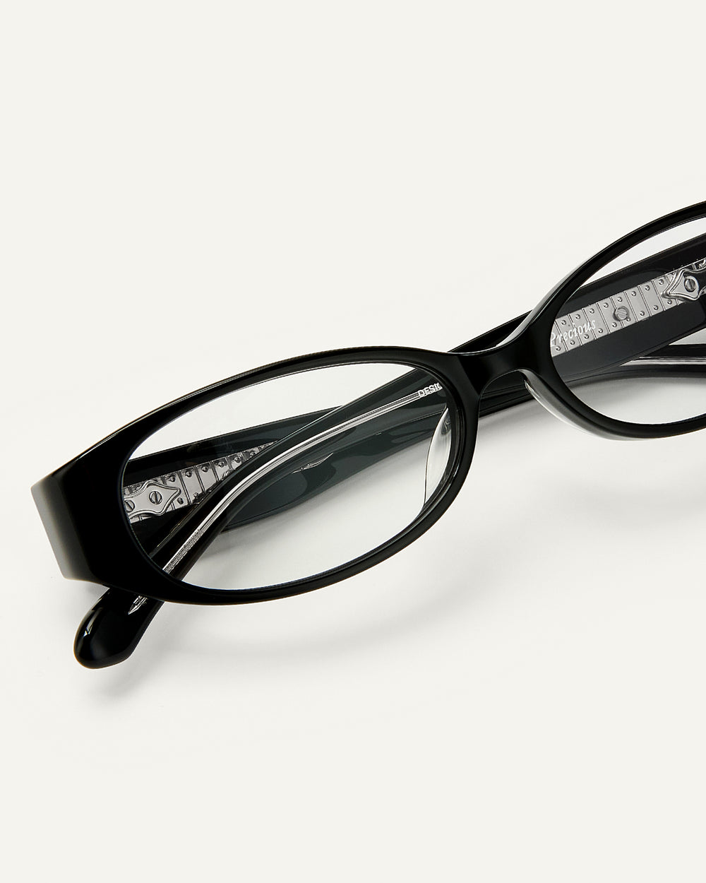 Close up shot of Bonnie Clyde Precious eyeglasses in black frames with clear lenses.