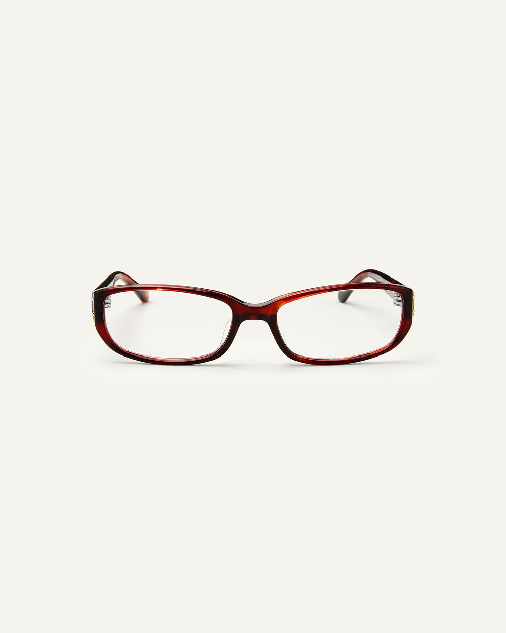 Face shot of Bonnie Clyde Triplet eyeglasses in red tortoise frames with clear lenses.